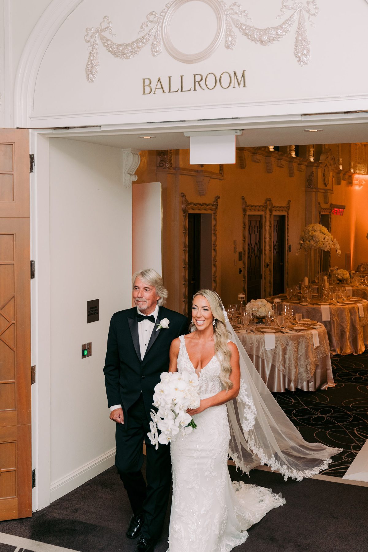 Bride walking the aisle on her father's arm into the Fairmont ballroom