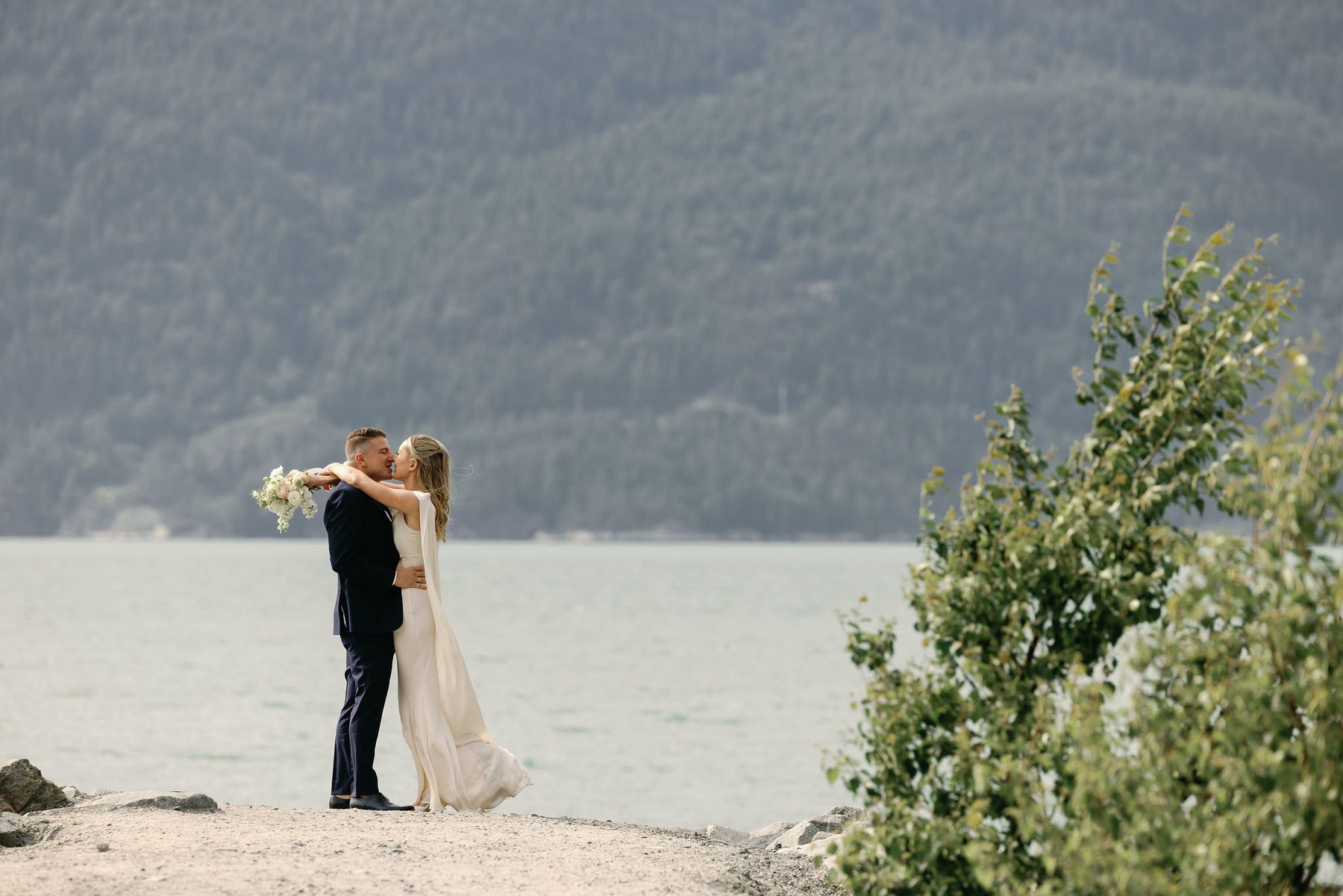 Couple kissing on the shoreline of Howe Sound