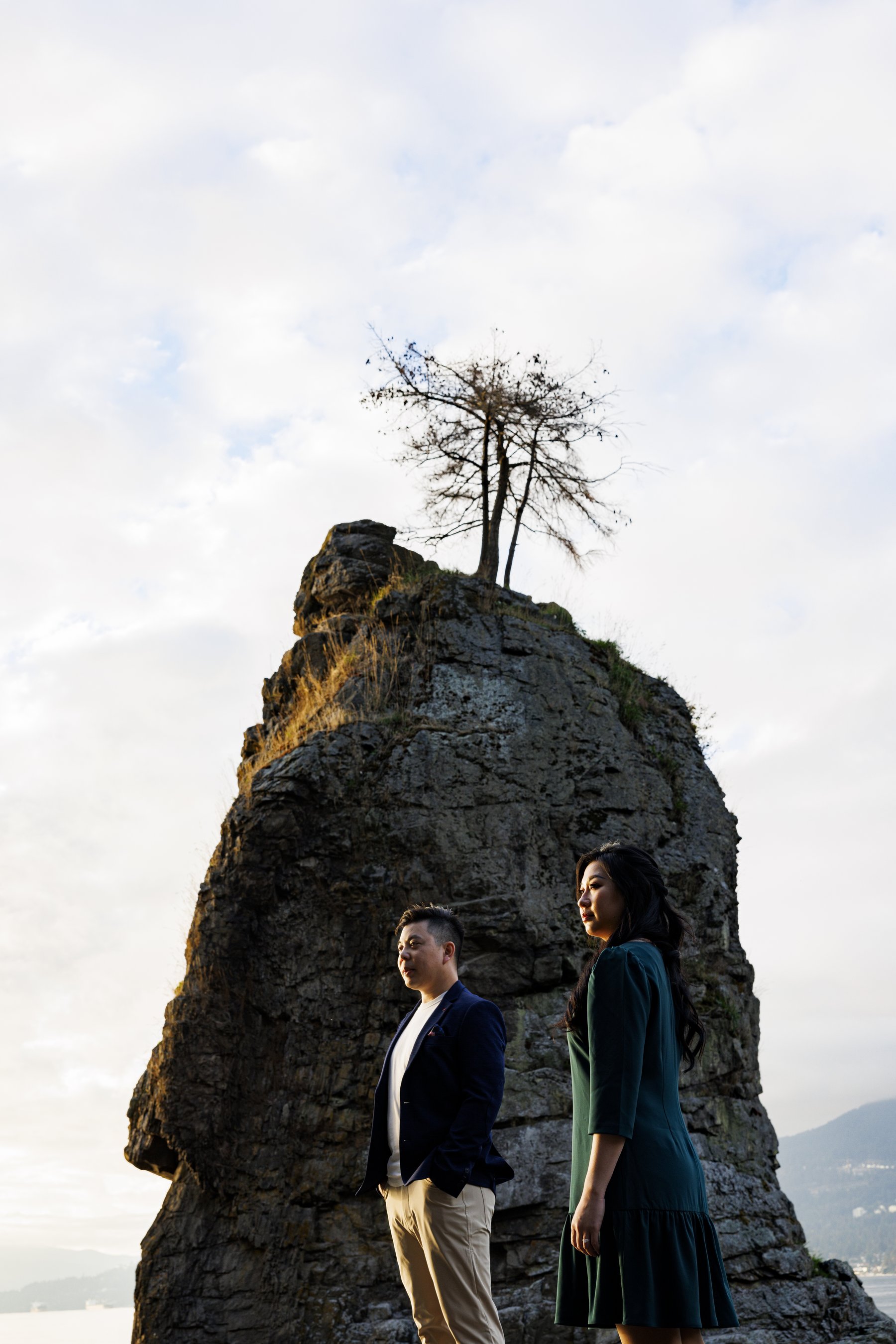 Couple alone at the base of Siwash Rock at dusk