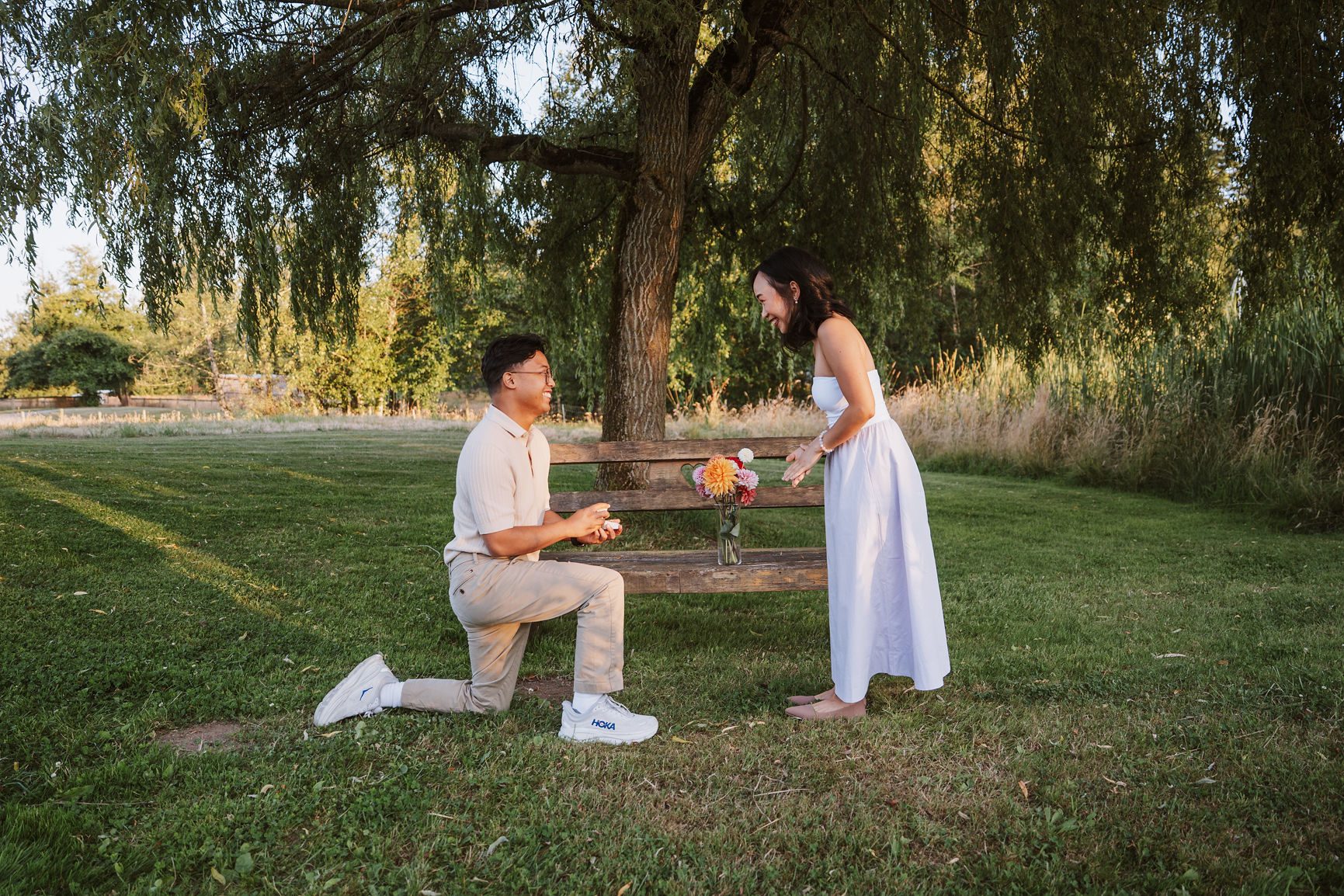 Proposal on one knee in a flower field at golden hour