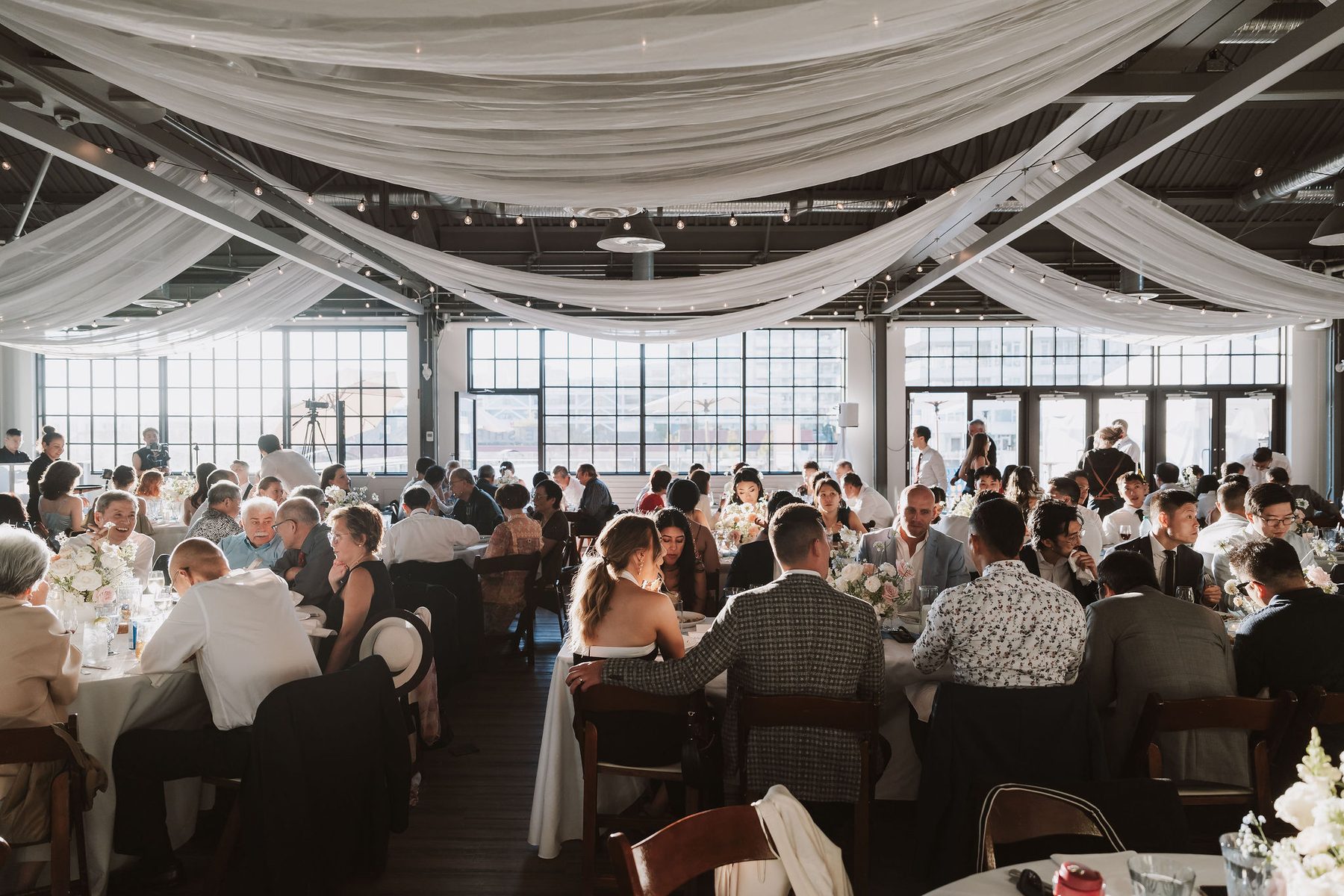 The Wallace at Lonsdale Quay set for a wedding reception with white draping and harbour windows