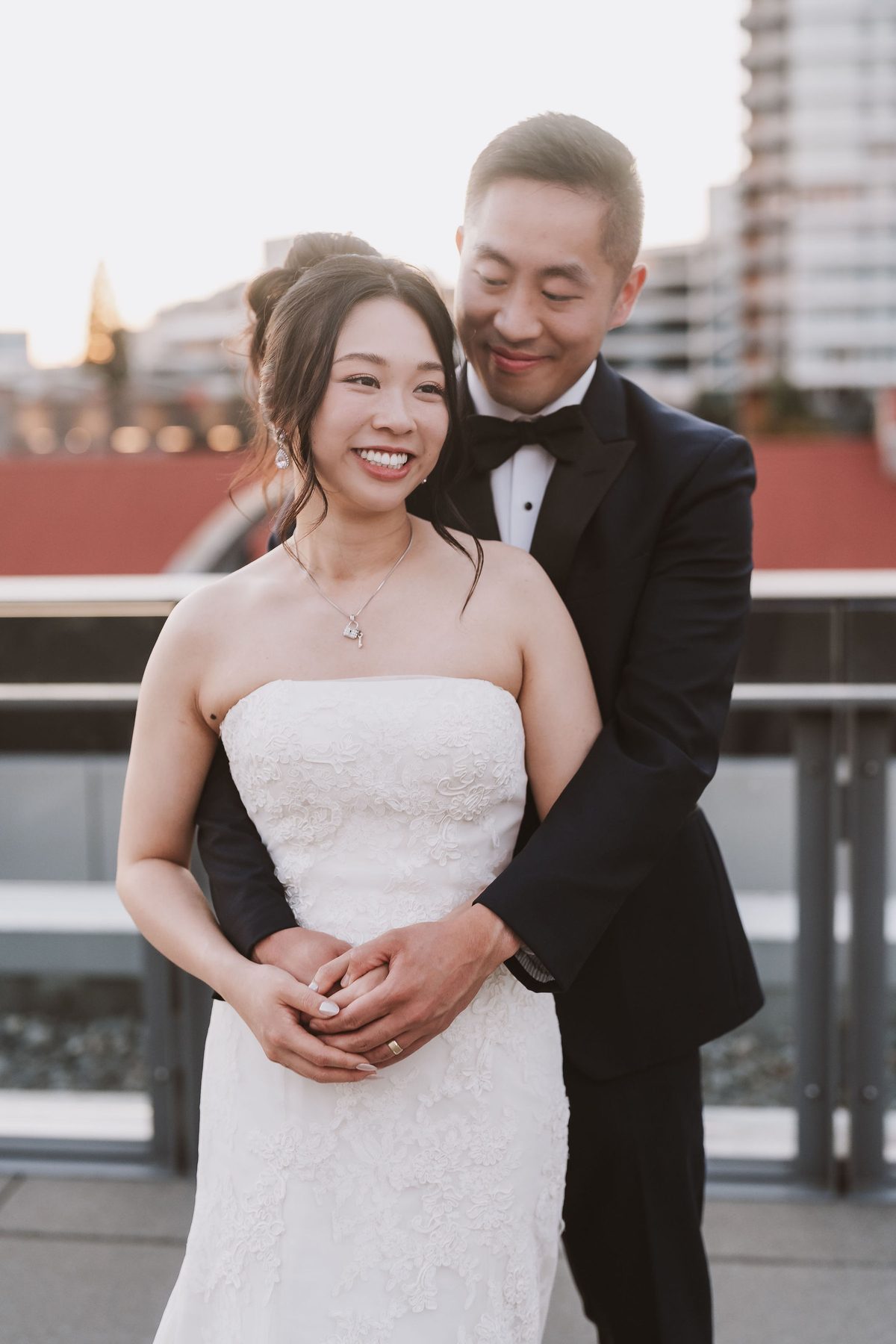 Bride and groom on The Wallace rooftop with the North Shore shipyards behind them
