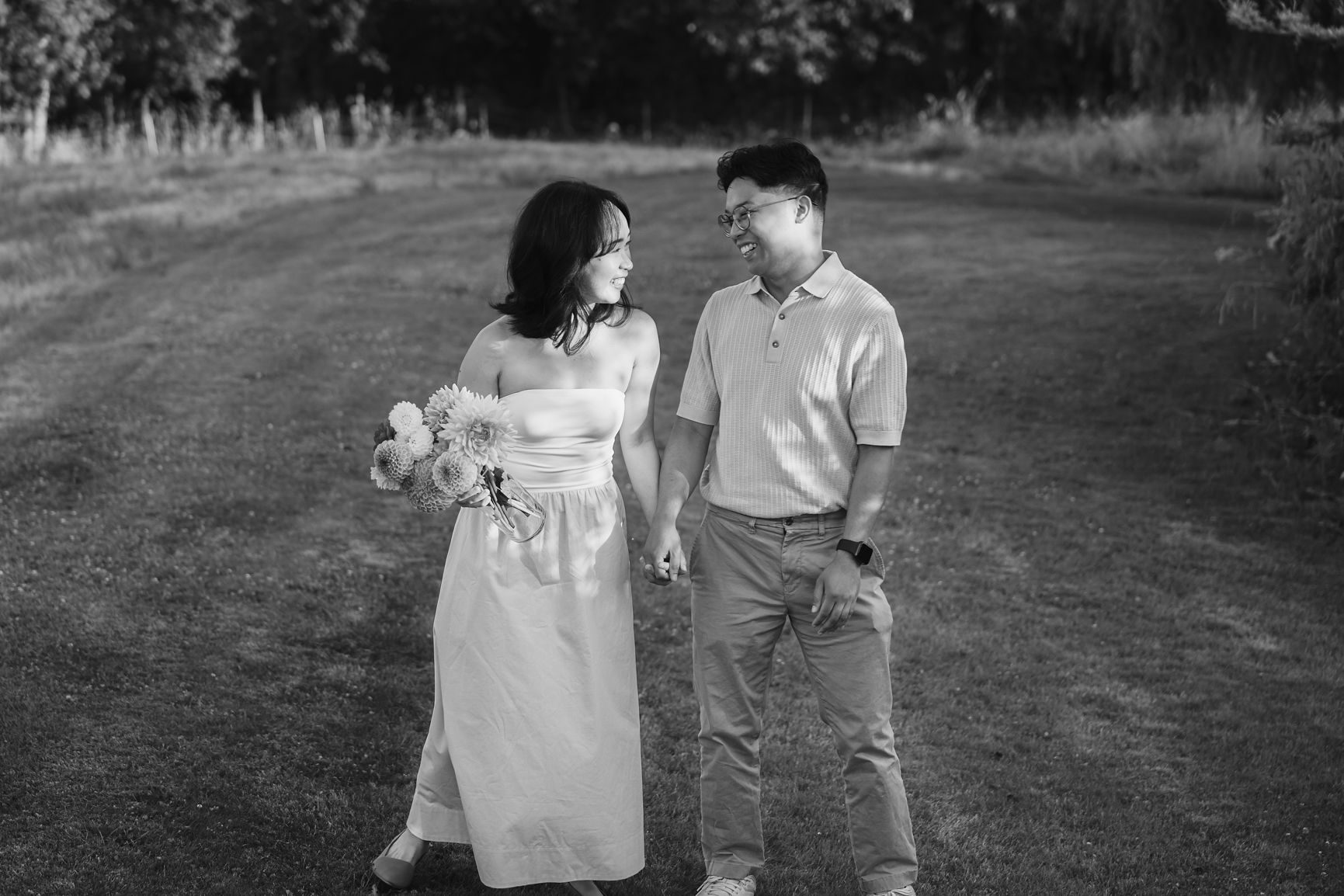 Black and white photograph of a couple walking a country path together